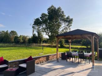 Patio, rear lawn and view of private farmland