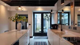 Modern kitchen with garden-facing doors at 59 William Street