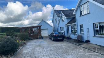 Back of house with pergola for outdoor entertainment
