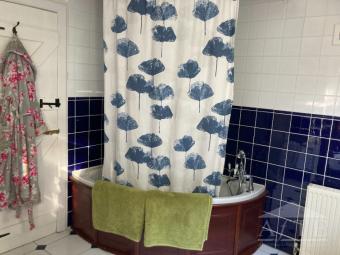 Family bathroom with bath and overhead shower.